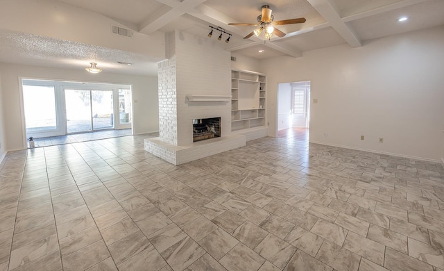 unfurnished living room featuring coffered ceiling, a textured ceiling, beamed ceiling, ceiling fan, and a fireplace