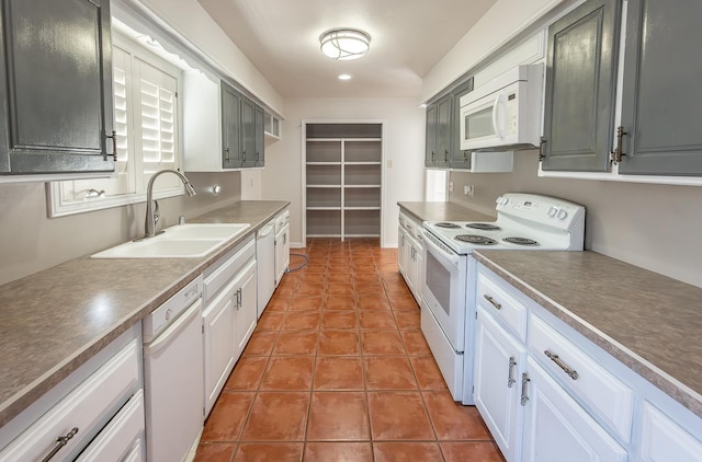 kitchen with gray cabinetry, sink, white appliances, and tile patterned floors