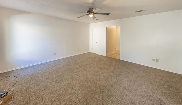 carpeted spare room featuring ceiling fan