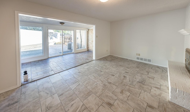 unfurnished room featuring a textured ceiling