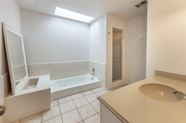 bathroom featuring tile patterned floors, vanity, independent shower and bath, and a skylight