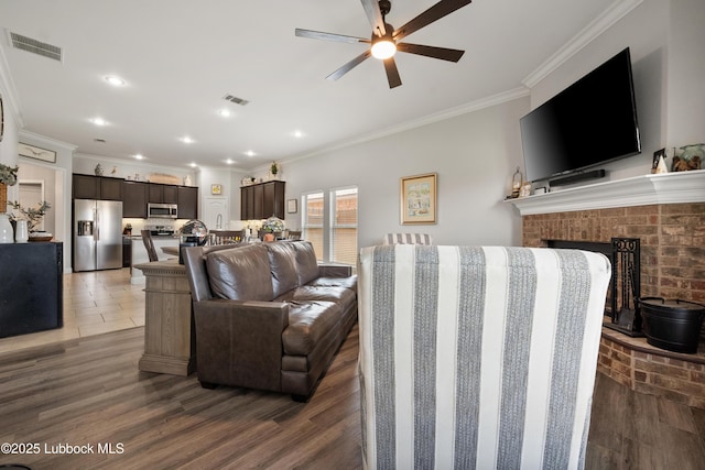 3634 Ridgely Ave, Lubbock, TX 79407 - living area featuring ceiling fan, a brick fireplace, crown molding, and recessed lighting