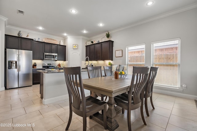 3634 Ridgely Ave, Lubbock, TX 79407 - dining space with light tile patterned floors, crown molding, and recessed lighting