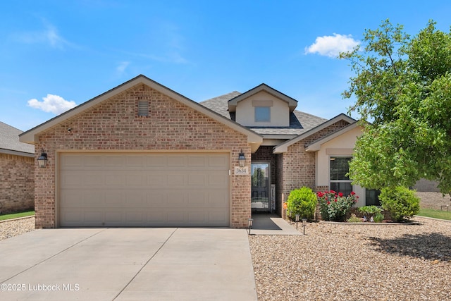 3634 Ridgely Ave, Lubbock, TX 79407 - view of front of property featuring driveway, brick siding, an attached garage, a shingled roof, and stucco siding