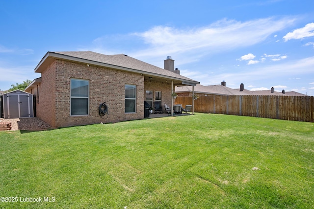 3634 Ridgely Ave, Lubbock, TX 79407 - back of house with brick siding, a patio area, a chimney, and a storage shed