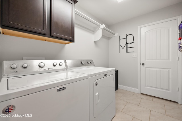 3634 Ridgely Ave, Lubbock, TX 79407 - laundry room with cabinet space, washer and clothes dryer, and light tile patterned floors