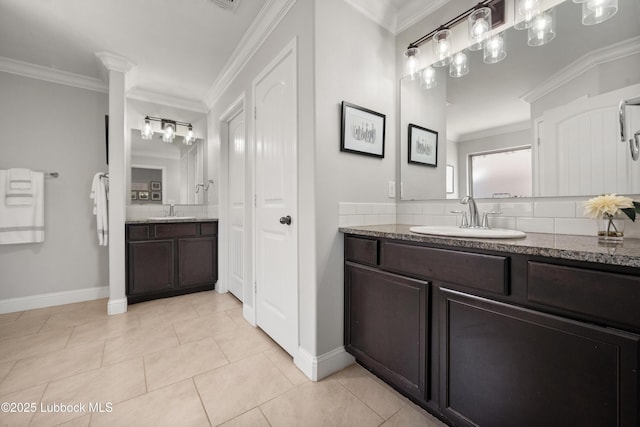 3634 Ridgely Ave, Lubbock, TX 79407 - bathroom featuring two vanities, tile patterned flooring, crown molding, and tasteful backsplash
