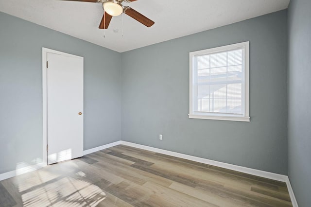 unfurnished room featuring ceiling fan and hardwood / wood-style floors