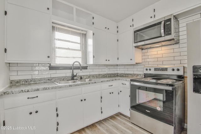 2014 60th St, Lubbock, TX 79412 - kitchen with stainless steel appliances, backsplash, and white cabinets