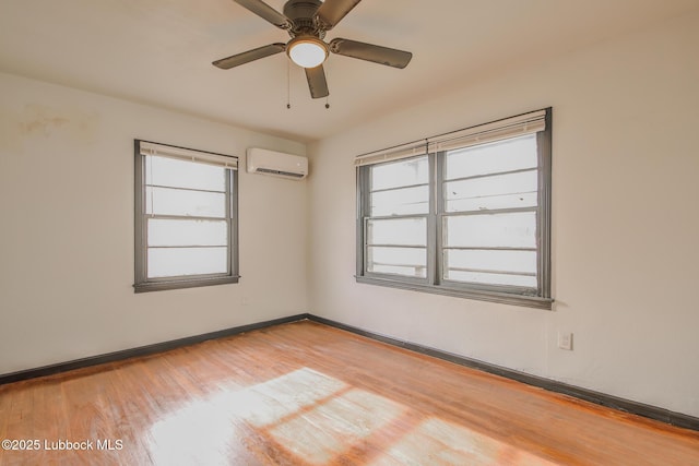 2014 60th St, Lubbock, TX 79412 - unfurnished room with a wall unit AC, wood finished floors, and a ceiling fan