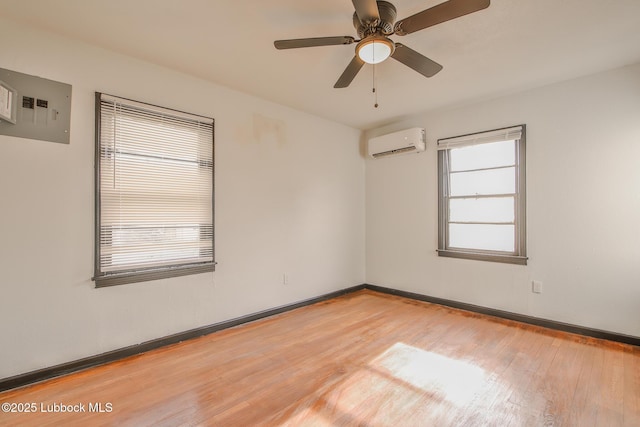 2014 60th St, Lubbock, TX 79412 - spare room with a wall mounted AC, light wood-style floors, and a ceiling fan