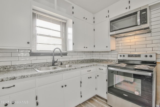 2014 60th St, Lubbock, TX 79412 - kitchen featuring appliances with stainless steel finishes, white cabinetry, and light countertops