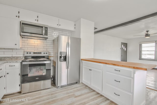 2014 60th St, Lubbock, TX 79412 - kitchen with stainless steel appliances, a peninsula, backsplash, and light wood-style floors