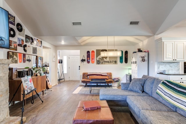 living room featuring wood-type flooring and lofted ceiling