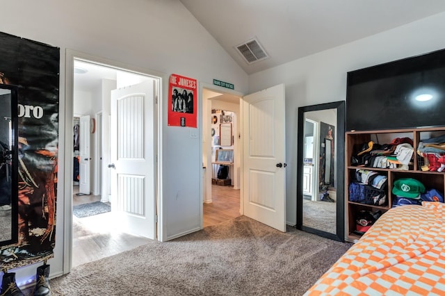 carpeted bedroom with vaulted ceiling