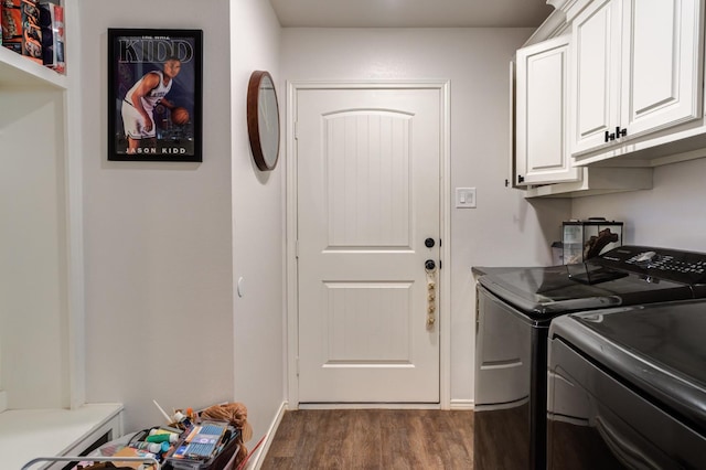 laundry room featuring dark hardwood / wood-style flooring, washer and clothes dryer, and cabinets