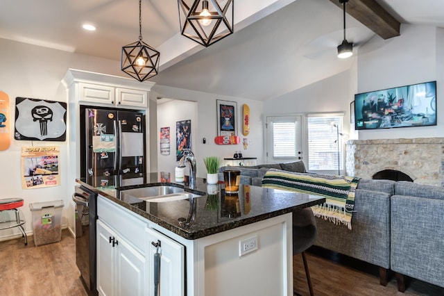 kitchen with refrigerator, white cabinetry, sink, dark hardwood / wood-style flooring, and a kitchen island with sink