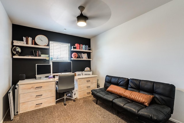 carpeted office space featuring ceiling fan