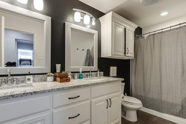 bathroom with vanity, hardwood / wood-style flooring, and toilet