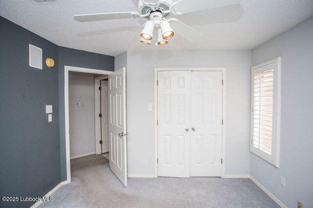 5110 1st Pl, Lubbock, TX 79416 - unfurnished bedroom featuring carpet flooring, a closet, multiple windows, baseboards, and a textured ceiling