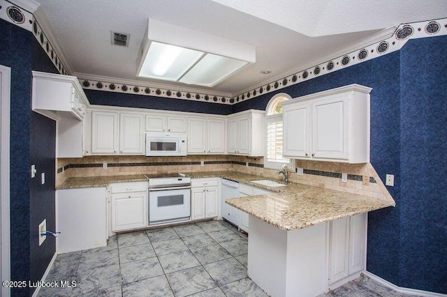 5110 1st Pl, Lubbock, TX 79416 - kitchen featuring white appliances, a peninsula, a sink, and backsplash