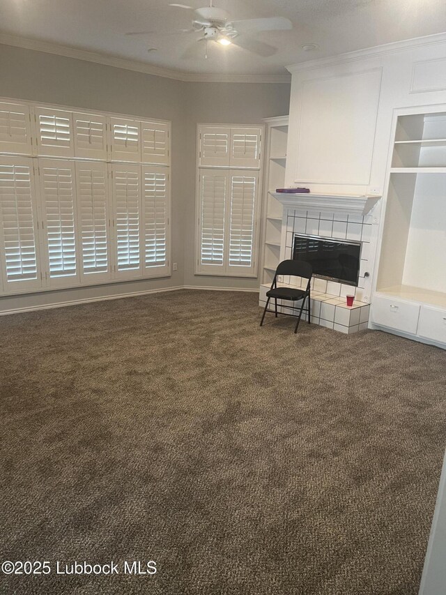 5110 1st Pl, Lubbock, TX 79416 - unfurnished living room with carpet flooring, crown molding, a ceiling fan, a tile fireplace, and built in features