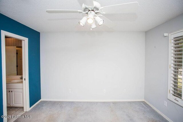 5110 1st Pl, Lubbock, TX 79416 - carpeted spare room featuring a sink, a ceiling fan, baseboards, and a textured ceiling