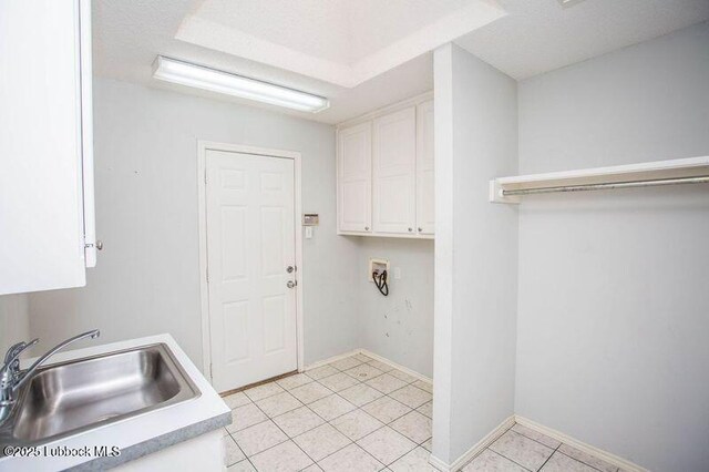 5110 1st Pl, Lubbock, TX 79416 - washroom featuring cabinet space, hookup for a washing machine, light tile patterned floors, and baseboards