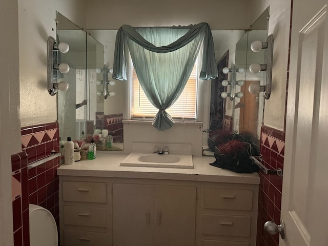 bathroom with vanity and tile walls