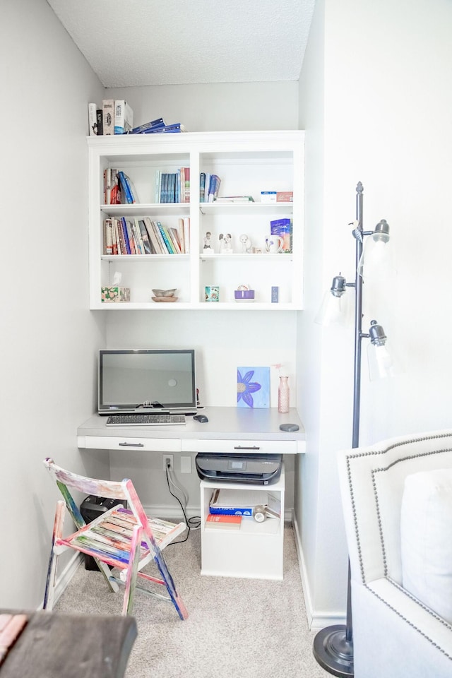 carpeted office space featuring baseboards