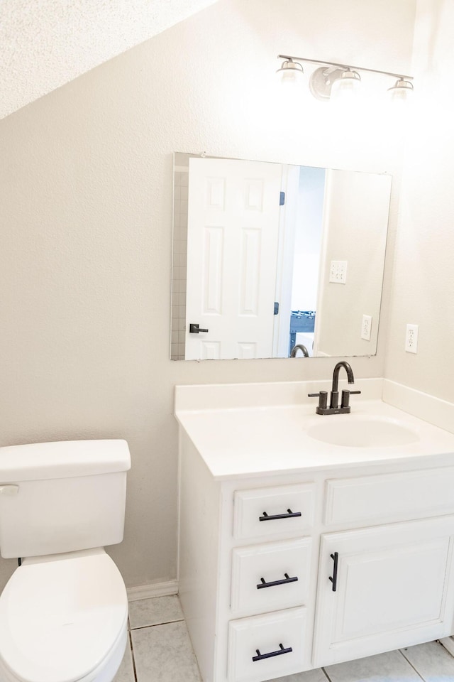 bathroom featuring tile patterned floors, vanity, and toilet
