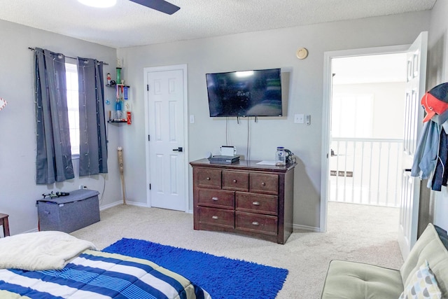 bedroom with baseboards, carpet, and a textured ceiling