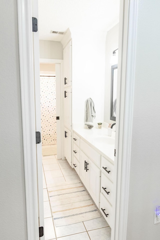 full bath with tile patterned floors, vanity, curtained shower, and visible vents