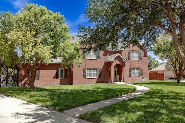 7416 95th St, Lubbock, TX 79424 - view of front facade with a front yard and brick siding