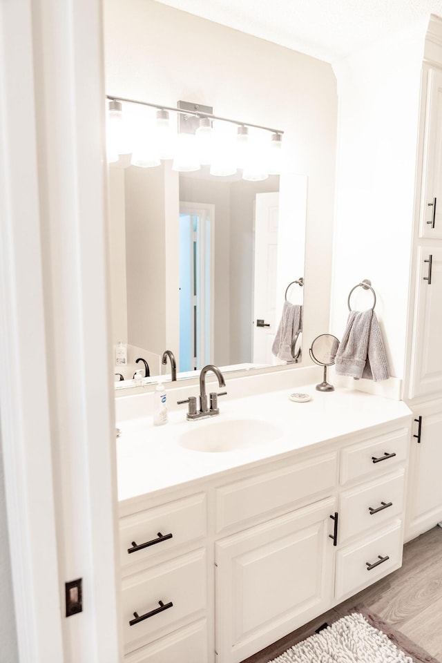 bathroom featuring vanity and wood finished floors
