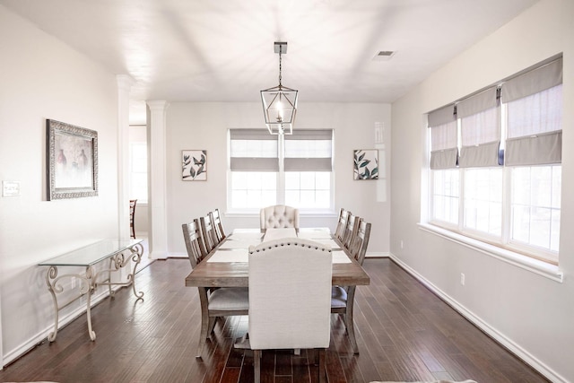 dining area featuring dark wood-type flooring, baseboards, and visible vents