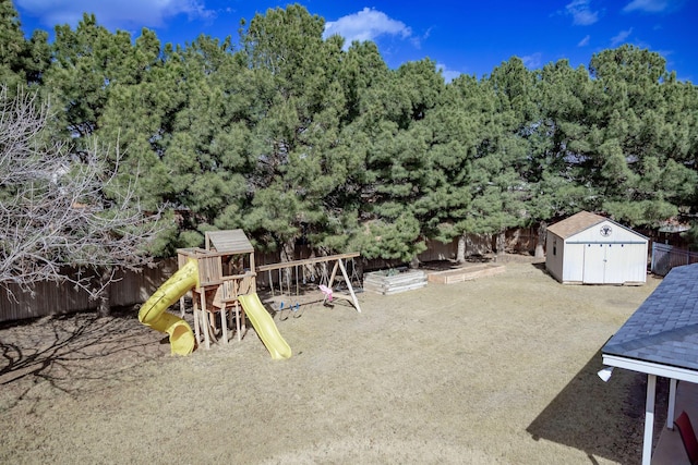 exterior space featuring a storage unit, a fenced backyard, and an outdoor structure