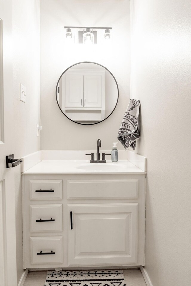 bathroom with baseboards and vanity