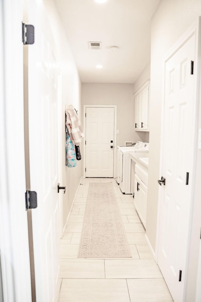 clothes washing area featuring cabinet space, visible vents, and independent washer and dryer