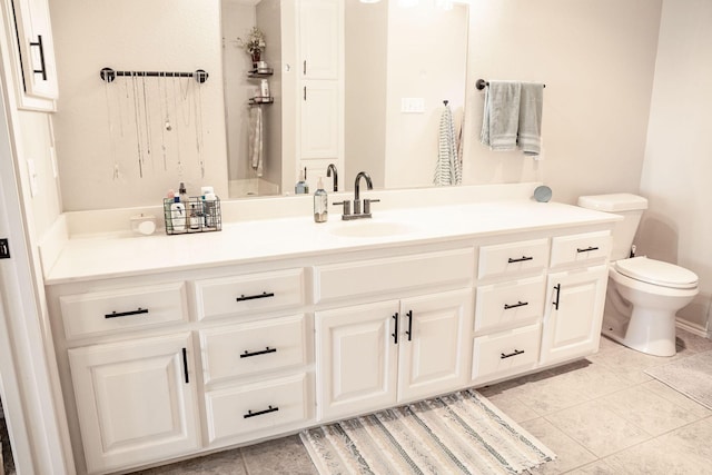 bathroom with toilet, tile patterned flooring, and vanity