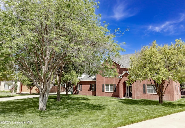 7416 95th St, Lubbock, TX 79424 - view of property hidden behind natural elements with a front lawn and brick siding