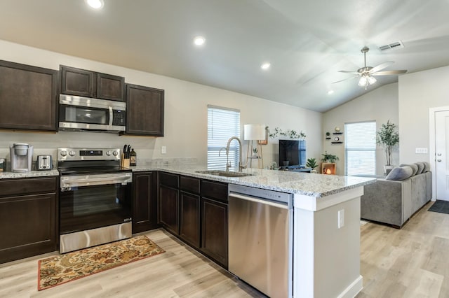 kitchen with appliances with stainless steel finishes, kitchen peninsula, and sink