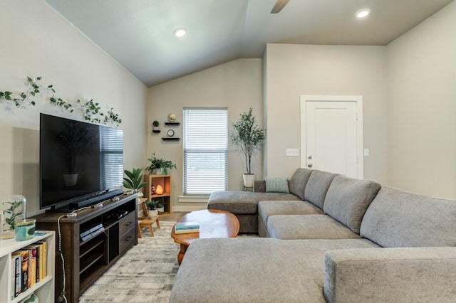 living room with vaulted ceiling, ceiling fan, and light hardwood / wood-style flooring