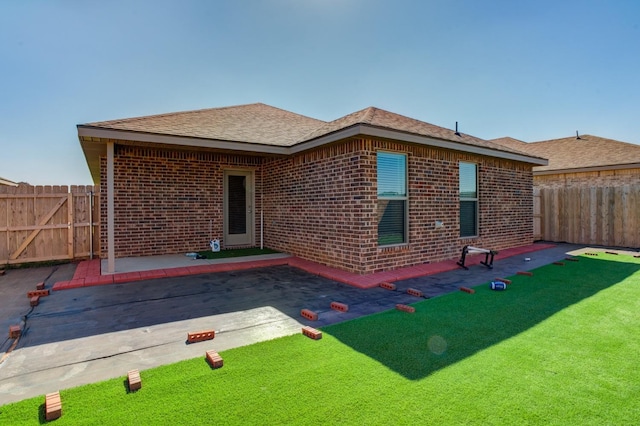 back of property featuring a yard and a patio area