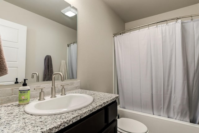 full bathroom with vanity, toilet, and shower / bath combo with shower curtain