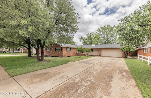 3417 56th St, Lubbock, TX 79413 - view of front of property with an attached garage, brick siding, and concrete driveway
