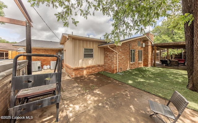 3417 56th St, Lubbock, TX 79413 - rear view of house featuring brick siding, a patio area, a chimney, and board and batten siding