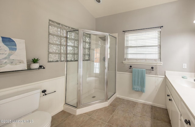 3417 56th St, Lubbock, TX 79413 - full bath featuring a shower stall, vanity, lofted ceiling, wainscoting, and tile patterned flooring