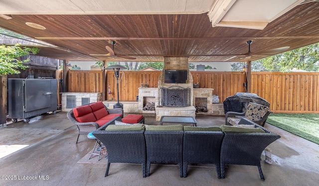 3417 56th St, Lubbock, TX 79413 - fenced backyard featuring an outdoor living space with a fireplace, a patio, and area for grilling