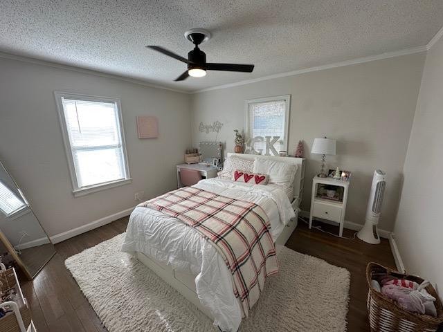 bedroom with crown molding, ceiling fan, dark hardwood / wood-style flooring, and a textured ceiling